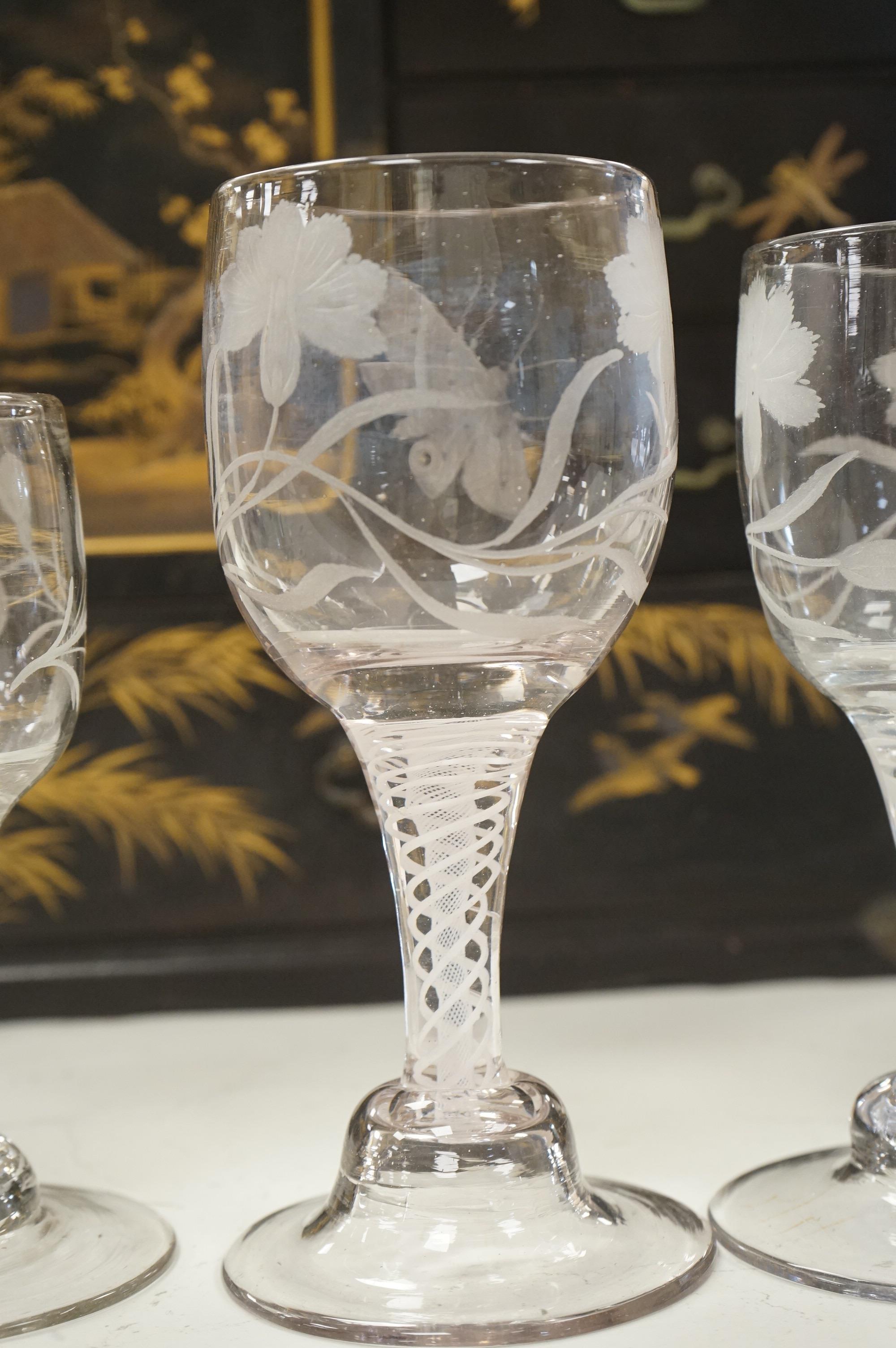 Three late 18th century Dutch DSOT stem goblets, each on a domed foot, engraved with a moth and flowers, 19.5cm and 18cm high